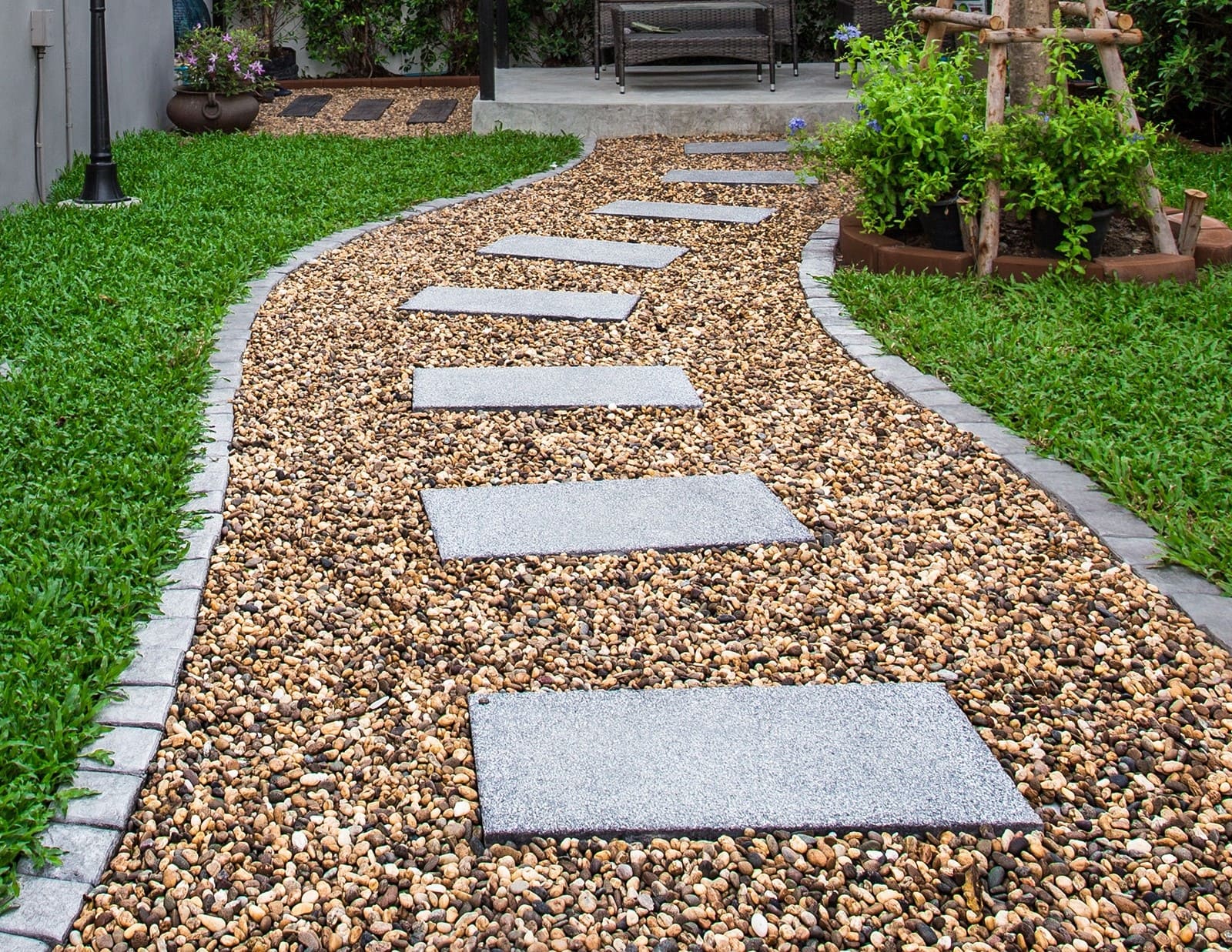 Beige white black mix color natural river pebbles in garden pathway